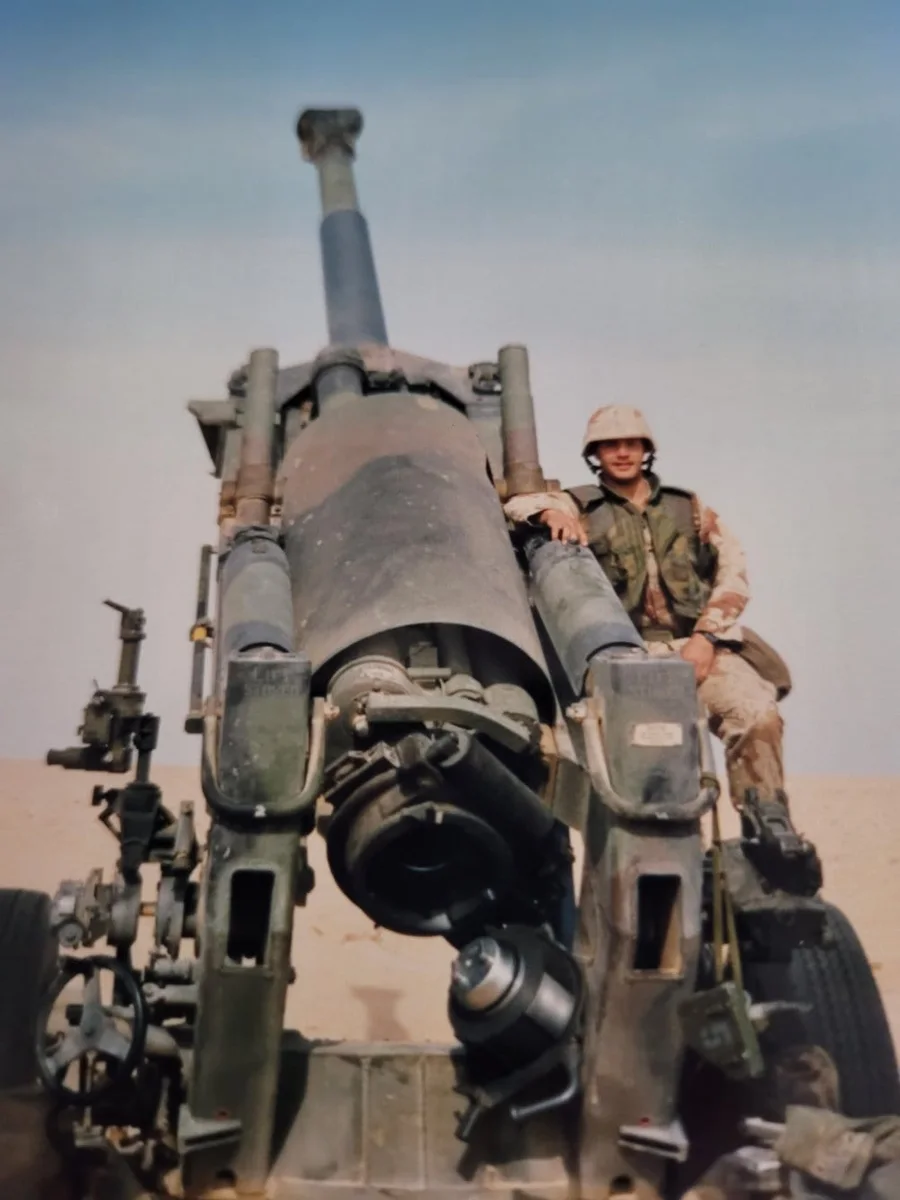 Harvey Betts with an M198 howitzer during his Marine Corps service