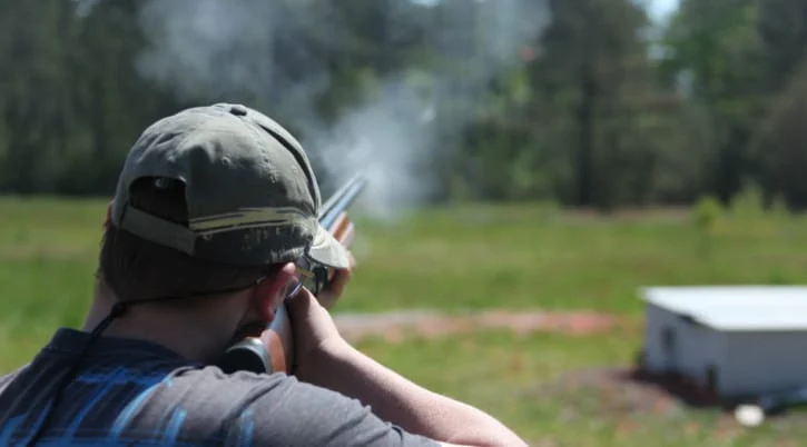Harvey Betts firing a shotgun on an outdoor range